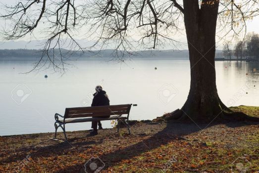 5950166-Lonely-Man-Sitting-Next-to-a-Lake-Stock-Photo-sad